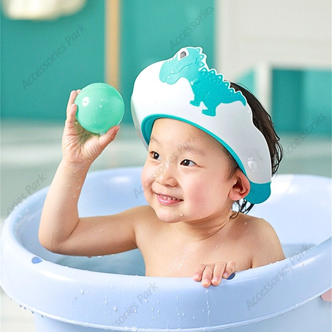 A baby is playing with a ball wearing a blue color shower cap
