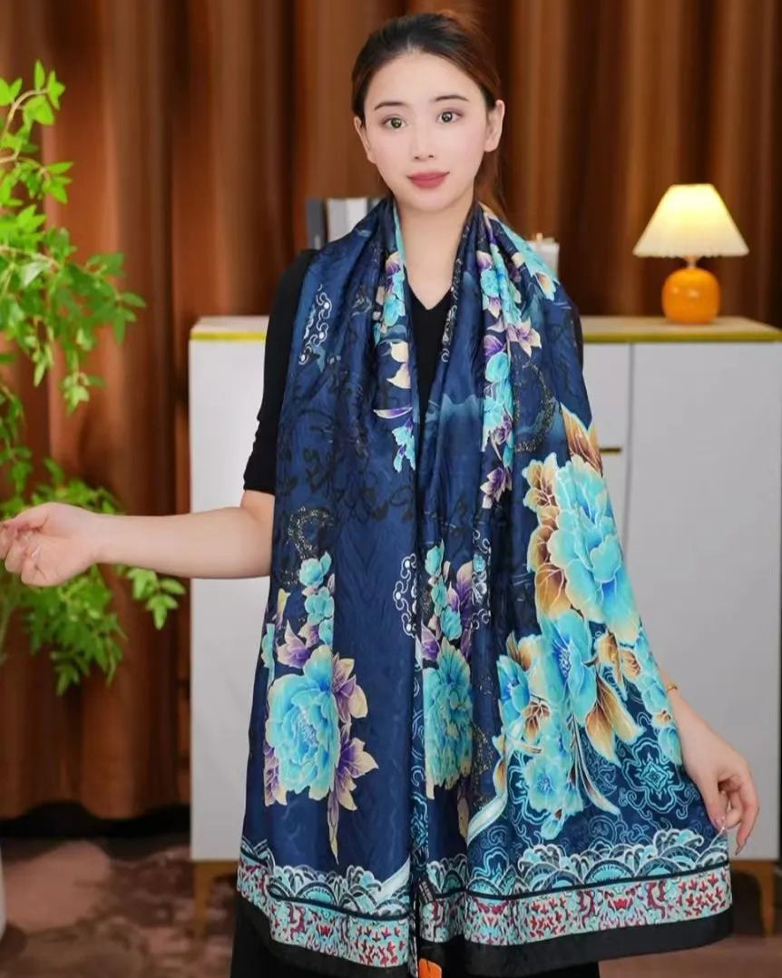 Woman wearing a blue floral scarf in an indoor setting