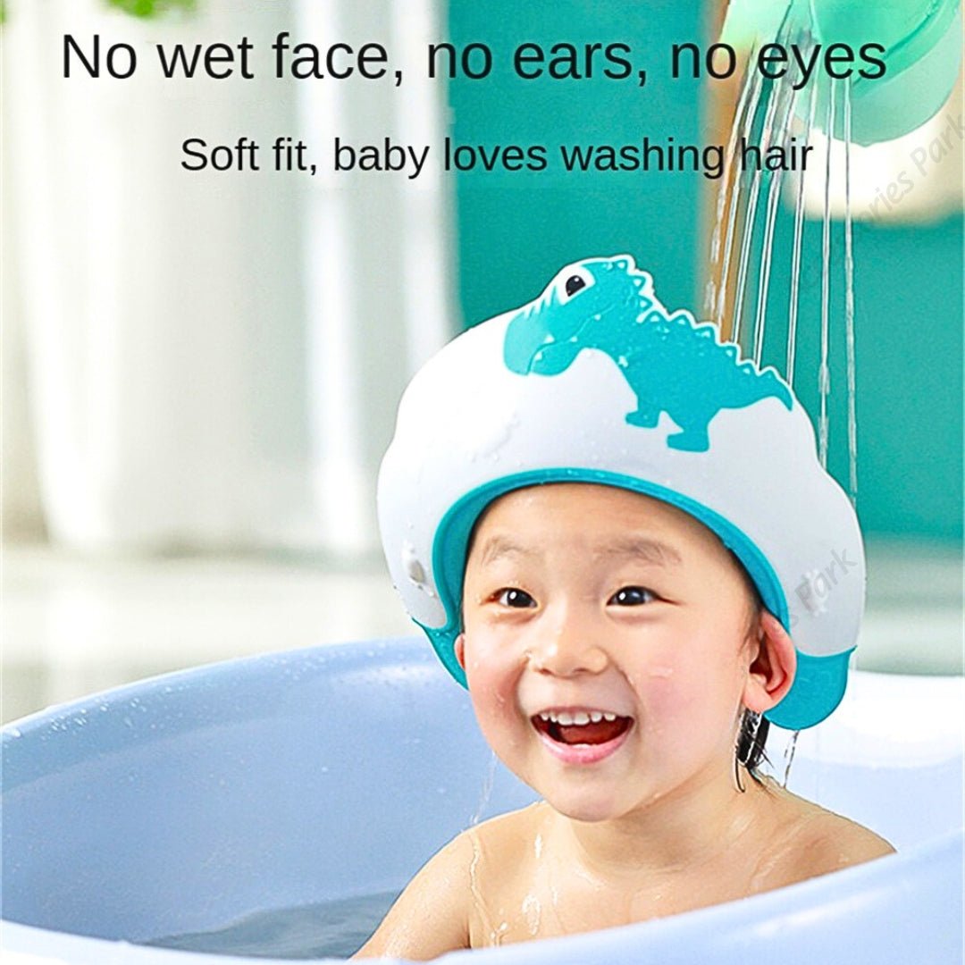 A baby is getting shower with a blue color shower cap