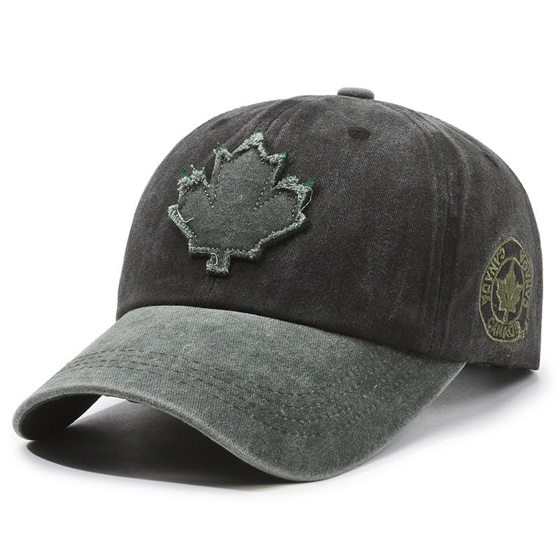 Dark gray baseball cap with a maple leaf design on a white background