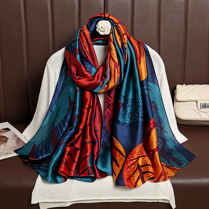 Colorful patterned scarf draped over a mannequin against a brown leather background.