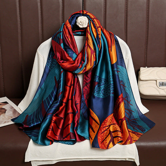 Colorful patterned scarf draped over a mannequin against a brown leather background.